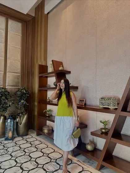 A bright and cheerful color-blocked dress. The lime green top and white skirt create a fresh and modern look.