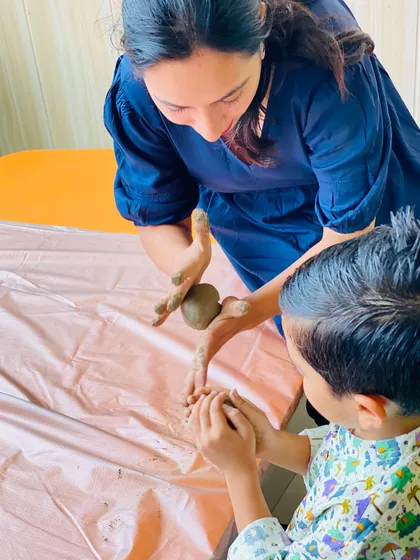 A heartwarming moment of collaboration between an instructor and a young boy. We believe in nurturing creativity through encouragement and shared creation.