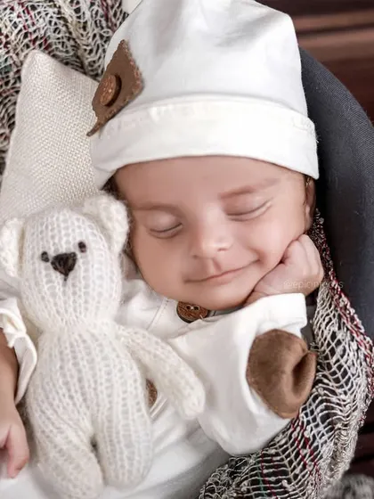 Another adorable smiling shot, showcasing the pure joy and contentment of a well-cared-for newborn during their session.