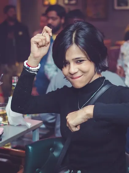 A partygoer showing off her dance moves at her table. The energy is everywhere at 'Mondaze'.
