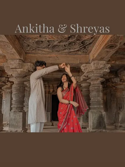 A wide shot of the couple dancing inside a heritage temple, framed by intricately carved pillars. This photo captures both the grandeur of the location and the joy of the couple.
