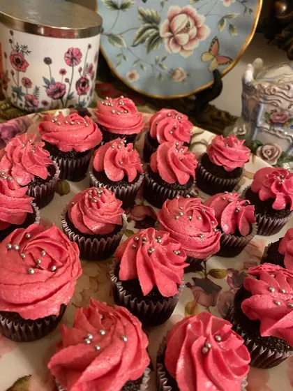 These mini moist chocolate cupcakes are topped with a pretty pink vanilla icing and silver sprinkles. They look so lovely on a dessert table.