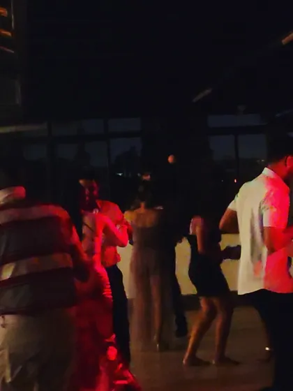 A more intimate party scene with guests enjoying a slow dance.