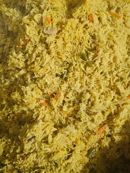 A large batch of our vegetable pulao, ready to be served to hungry guests.