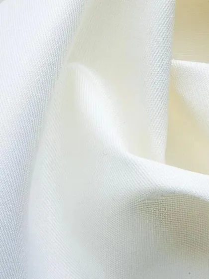 The pure, clean texture of a high-quality white cotton fabric, the foundation for the perfect white shirt.