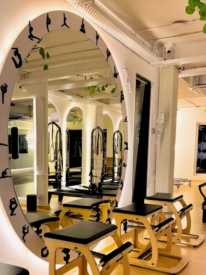 This custom mirror is a centerpiece at the GK-1 studio. It's framed with silhouettes of classic Pilates poses to inspire your workout.