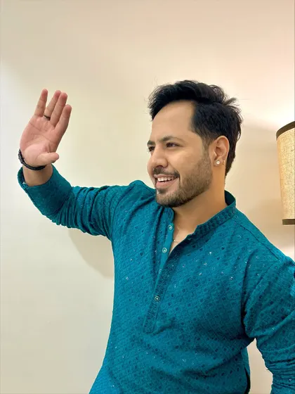 A side profile with a wave in the teal kurta. This is a great shot for an event poster or a social media announcement.