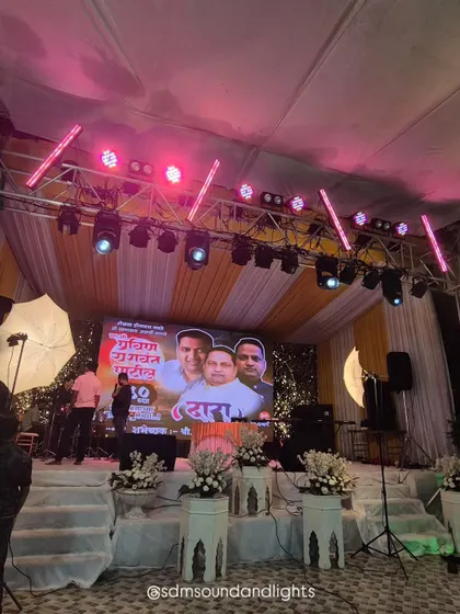 The same stage, but with the lighting changed to a vibrant pink. This shows the versatility of using programmable lights to completely alter the mood and color scheme of the event space in an instant.