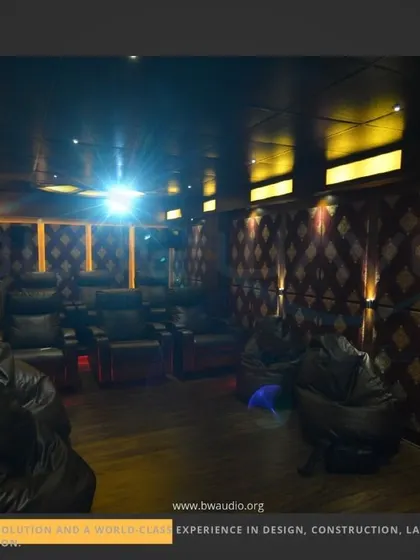 A flexible media room setup combining traditional recliners with casual beanbag chairs. This approach is perfect for families and creating a relaxed, multi-use entertainment space.