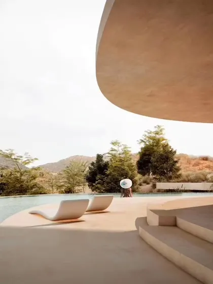 The Amar Villa in Udaipur, a boutique hotel designed as a seamless calligraphic curve that follows the site's natural topography. The architecture is designed to maximize breathtaking mountain views while blending into the surrounding landscape.