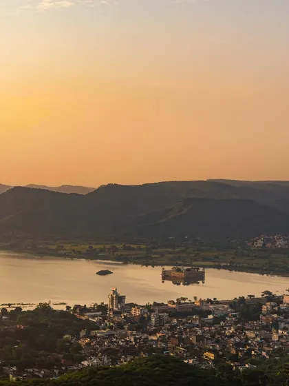 A stunning landscape shot of Jal Mahal in Jaipur at sunset. This sets the scene for the kind of epic, beautiful backdrops we use for destination shoots.