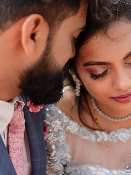 A tight, emotional close-up of the couple. This shot focuses on their serene expressions and the tender connection between them, ignoring the background.
