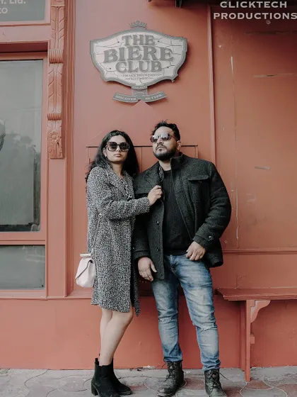 Another stylish pose of a couple in winter wear, looking away from the camera, creating a high-fashion, editorial feel.