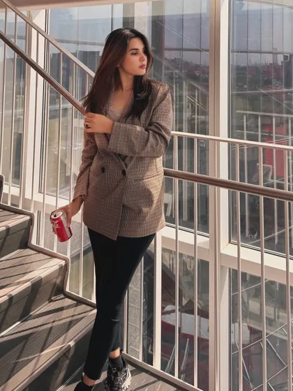 Posing on the stairs in my go-to college outfit, a plaid blazer and black leggings.