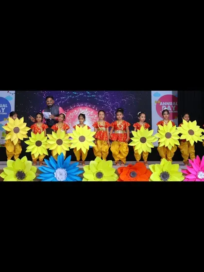 Joining the young performers on stage for a photo. It's important to make everyone, from the youngest to the oldest, feel like a star.