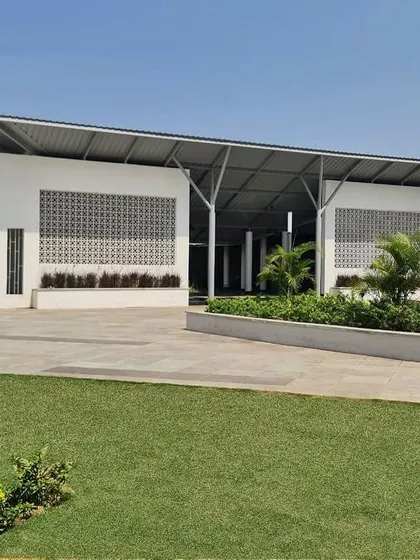 The new food court at Hill Side Town, JSW, is designed as a vibrant community hub. The open structure, with its high roof and jali screens for ventilation, creates a comfortable and inviting space for residents to gather and socialize.