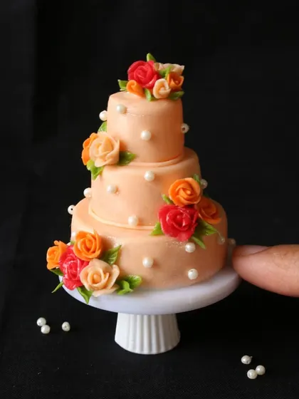 A stunning three-tier floral wedding cake miniature, one of the advanced projects in my cake course.