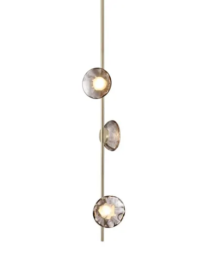 A studio shot of a vertical Ceto lamp with a champagne aluminum body, offering a softer and warmer alternative to the black finish.