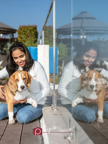 A Beagle and his mom enjoying a sunny day by the pool. The reflection in the glass adds a creative, artistic layer to the photo.