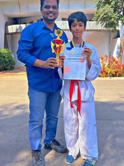 A proud student with his trophy and certificate from the 7th KTA Cup Taekwondo Championship.