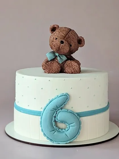 A simple and sweet cake for a 6-month celebration. This design features a cute teddy bear and a quilted number six.