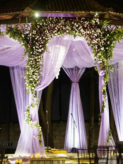 The ambiance before guests arrive holds a quiet magic. This shot of Ridhi and Prashanth's cocktail party setup at The Tamarind Tree shows the elegant stage and seating we prepared for an unforgettable night.