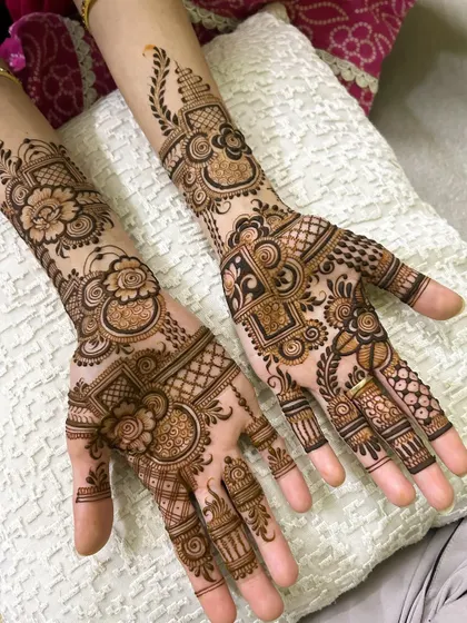 A beautiful example of a full-coverage design for both hands. The mix of floral, geometric, and traditional Indian patterns ensures a rich and festive look.