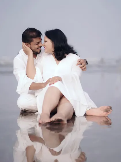 A beautiful reflection shot on the wet sand. This artistic approach adds a unique and memorable element to their beach photoshoot.