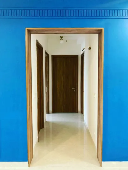 “A door way to happiness.” A bold, vibrant blue accent wall with classic moulding, creating a dramatic and happy entryway.
