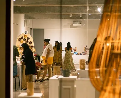 A view of the exhibit hall, filled with beautiful displays and enthusiastic visitors. The atmosphere is always buzzing with creative energy.