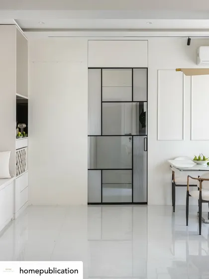 A wide shot of a minimalist dining and living area from my 'Soothing Antidote' project. The design focuses on clean lines and a monochrome palette, where the geometric glass door itself becomes a form of art.