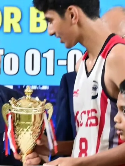 A close-up of our team captain receiving the championship trophy, a proud moment for the player and the academy.