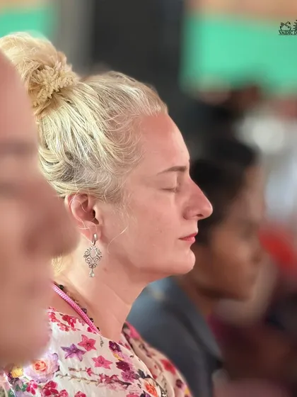 A participant from overseas deep in meditation during a Homa ceremony. The spiritual vibrations and serene environment of our center attract seekers from every corner of the globe.