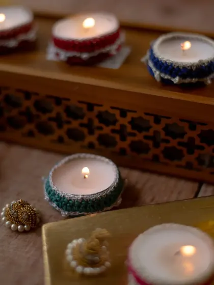 A cozy, ambient shot of our crochet diya jackets in action. These simple, elegant holders add a handmade touch to every corner, creating a warm and inviting atmosphere for the festival.