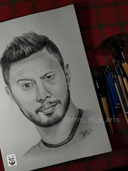 Another angle of my Jaby Koay portrait, this time laid out on my workspace with my blending brushes. This shows the finished artwork ready for display.
