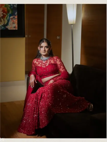 A relaxed portrait of the bride on a sofa, looking elegant and confident.