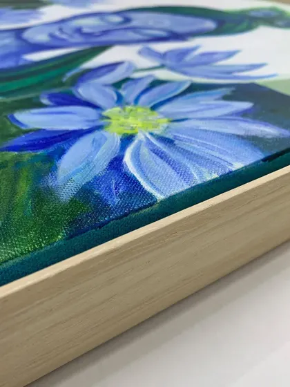 A detail shot showing the texture of the canvas within the floater frame. This style allows the entire painted surface, including the sides, to be visible.