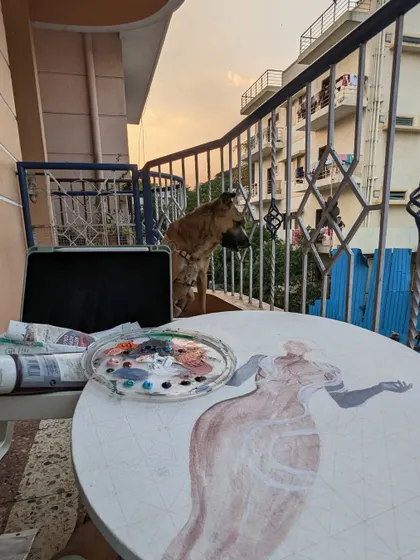 My painting companion enjoying the sunset from the balcony while I work. The evening light is always so inspiring.