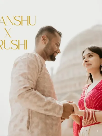 A lovely portrait of a couple sharing a look, with a historic dome in the background. Their traditional outfits complement the setting, making for a perfect cultural pre-wedding photo.
