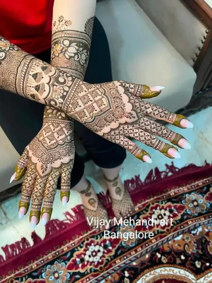 A full view of a client's beautiful mehndi, showing how the design flows from her hands to her arms. Home service is available anywhere in Bangalore.
