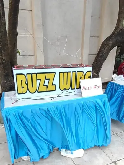 The buzz wire game tests focus and a steady hand. Players must guide a metal loop along a winding wire without touching it and setting off the buzzer.