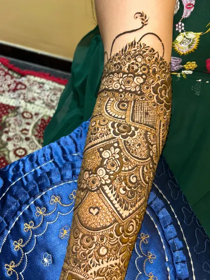 Another close-up of the intricate patterns on the arm. This design includes a small heart, a sweet personal touch.