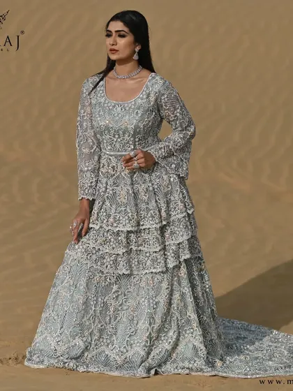 A full view of the glamorous sea-green Indo-western double-layered bridal silhouette, with its rose gold net dupatta.