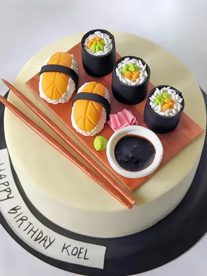Sushi makes me so happy! A fun and realistic sushi-themed cake, complete with edible nigiri, maki rolls, chopsticks, and soy sauce.