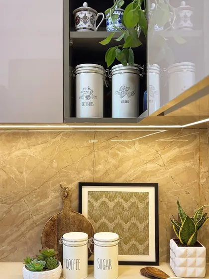 It's all in the styling. This kitchen countertop vignette shows how curated accessories, plants, and canisters can bring warmth and personality to a functional space.