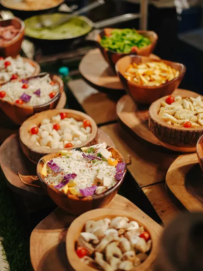 Our live counters feature a variety of fresh ingredients for guests to choose from. This display of colourful vegetables and toppings allows for a customized and healthy meal.