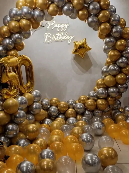 A classic and elegant 50th birthday celebration. We created a full circle balloon frame with chrome gold and silver balloons, a "Happy Birthday" neon sign, and large '50' foil numbers.