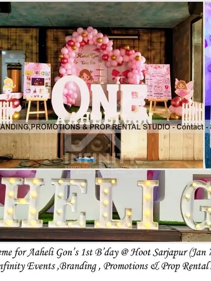 A simple and elegant little fairy theme for a first birthday at Hoot Sarjapur. The decor features a semi-arch backdrop with a pink balloon garland, a "ONE" table, and a personalized milestone board, creating a sweet and charming setup.