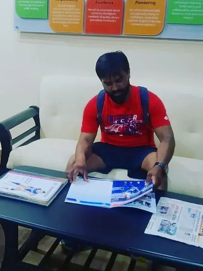 The grind isn't just on the field. Here, one of my coaches studies game plans and player performance reports, because dedication to the game happens off the pitch too.