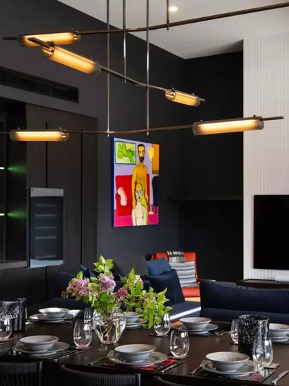 The linear configuration of the Volant makes it ideal for this modern dining area. Its modular nature allows it to span across the table, providing even illumination and a strong design statement.